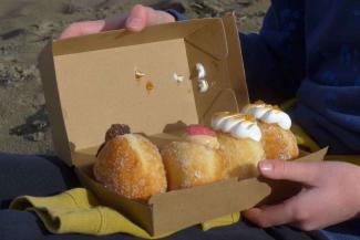 Box of filled doughnuts being opened