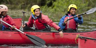 Group of young people canoeing at YHA Edale Activity Center 