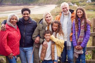 Family on a winter walk by the seaside