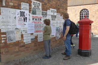 Father and son looking at posters in Ironbridge