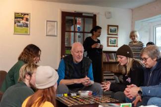 Family playing a board game in a hostel