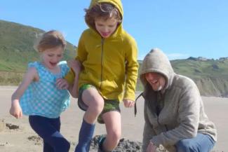 Dad on a beach with two children