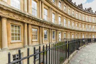 Row of curved stone houses with large sash windows