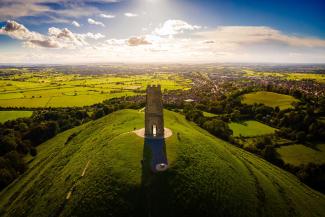 Stone monument on top of a hill overlooking countryside