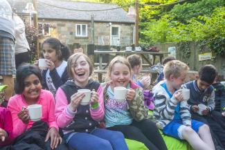 Group of children having a cuppa at YHA Boggle Hole