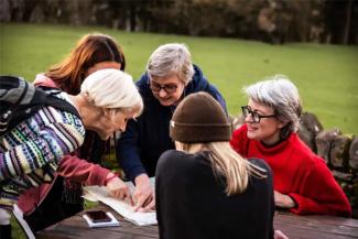 Group of women looking at a map outside