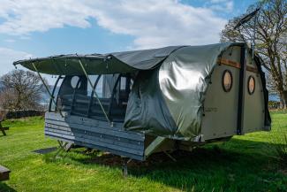 Landpod in camping field on a sunny day at YHA Windermere