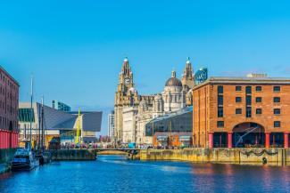 Historic and modern buildings surrounding a river