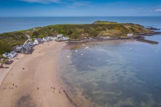 Village of white painted houses leading onto a beach and out to sea