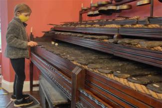 Child using musical stones in Keswick