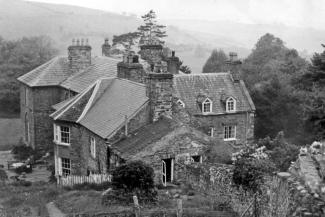 Black and white archive photo of a stone hoste building