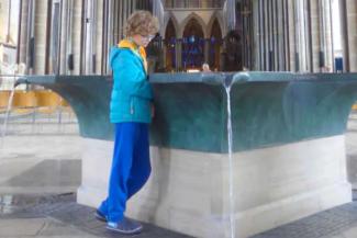 Young boy looking into the font inside a cathedral