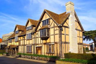 Tudor house with wooden beams and and stone chimney