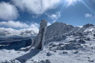 Snowy mountain landscape under a blue sky