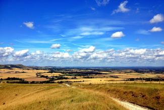 View over vast countryside with blue skies above