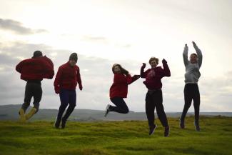 Group of children jumping in a field