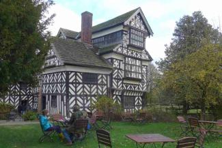 Family sat in front of Tudor house in Chester