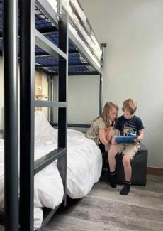 Two children sat on a bunkbed at YHA Bath