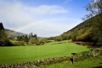 Rainbow in a blue sky over the countryside