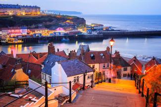 View down some steep steps over a pretty harbour surrounded by houses