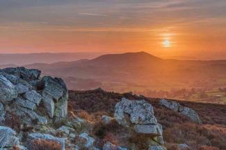 Sun setting over a countryside landscape