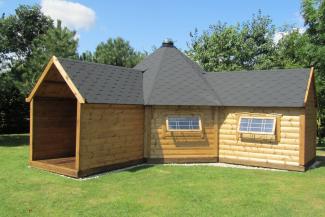 Wooden cabin on a grass field