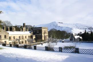 Stone hostel building of YHA Ilam Hall in the snow