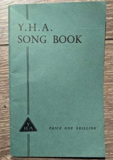 Green book cover with the words 'YHA Song Book' printed on it