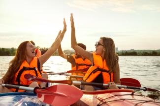 Young people kayaking on a lake