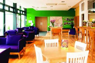 Seating area with sofas and dining table at YHA York