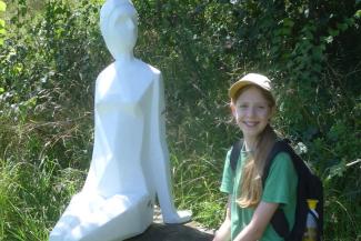 Young girl sat with statue