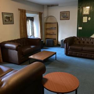 YHA Mankinholes Lounge area with sofa and fireplace