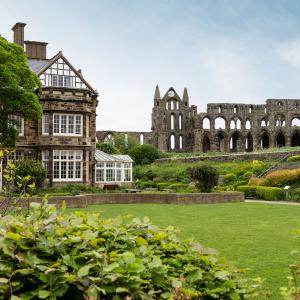 Exterior of YHA Whitby with Whitby Abbey in the background