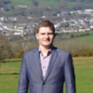 Man wearing a suit while standing in the countryside