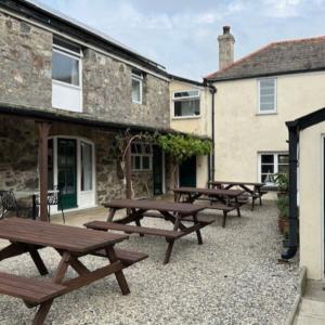 Courtyard outside a stone building with picnic benches