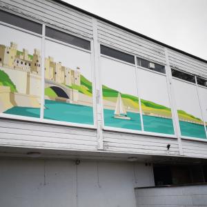 Artwork of Conwy Castle on the side of YHA Conwy