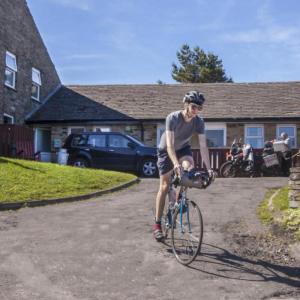 Cyclist by YHA Hawes entrance