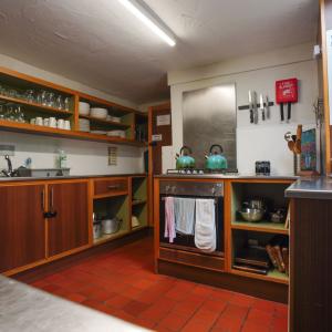 Kitchen with cabinets, oven and kettles