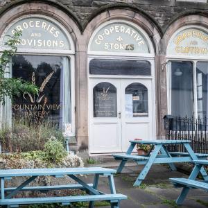 Outdoor seating area with benches and view of the bakery