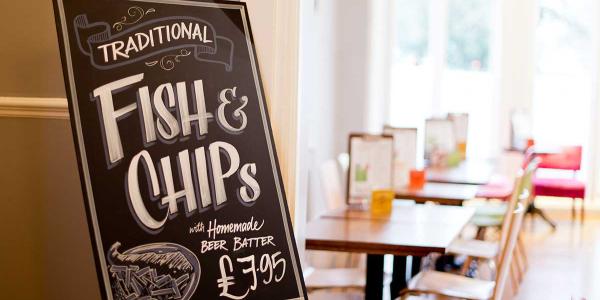 YHA Brighton Food and Drink board promoting fish and chips