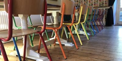 Dining room with a table and brightly coloured chairs