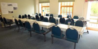 Light, airy room with rows of tables and chairs