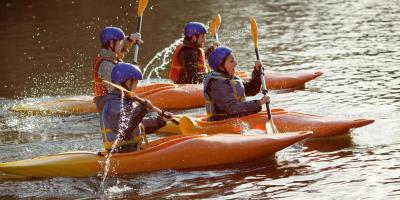 Kayaking group on a still lake