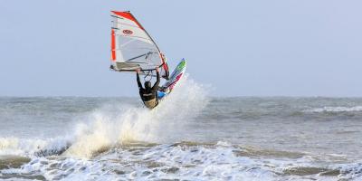 Windsurfer taking a jump, off Gower