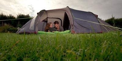 Two adults in a camping tent