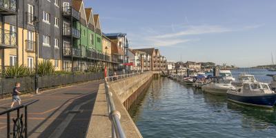 Littlehampton riverfront, with apartment houses and moored river cruisers