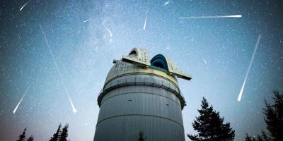 Astronomical Observatory with asteroids and comets in night sky