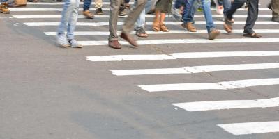 Groups of people walking across a street