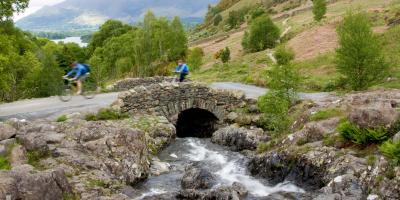 Couple cycling in the Lake District, Cumbria