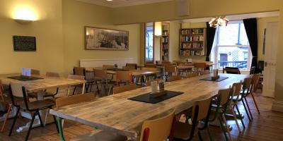 Dining room with tables and brightly coloured chairs